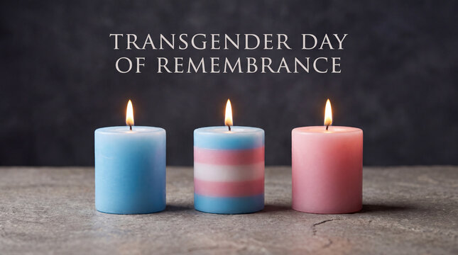 Three burning candles in blue, pink and the transgender flag colors, commemorating the Transgender Day of Remembrance.