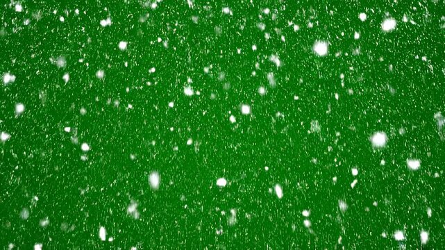 Green abstract background with falling white particles during a soft focus cinematic motion