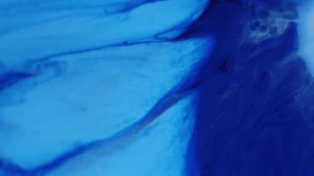 Ink dissolving. Hypnotic fluid. Blue liquid blotch blur stream floating abstract emulsion background. Dye splatter spread color dripping.