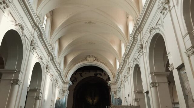 Beautiful interior views of the historic Salerno Cathedral showing its majestic white vaulted nave, religious Byzantine gold mosaics, ancient frescoes, and ornate altars in Campania region,