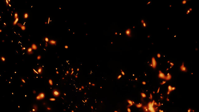 Fiery sparks illuminating a dark background in a dramatic close-up scene of glowing fire particles and embers.