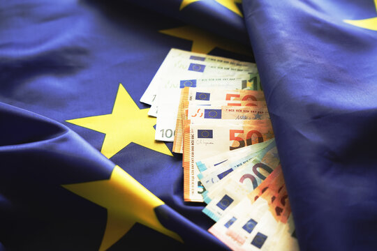 Euro banknotes cash money on European Union flag background