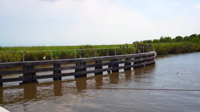 Humble Canal at Freshwater City, owned by the Louisiana Department of Transportation and Development, is a pontoon swing bridge over the canal dug in the 1980s by petroleum producers.