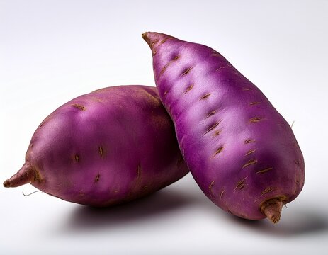 two vibrant whole purple yams also known as ube or purple sweet potatoes isolated against a clean white background