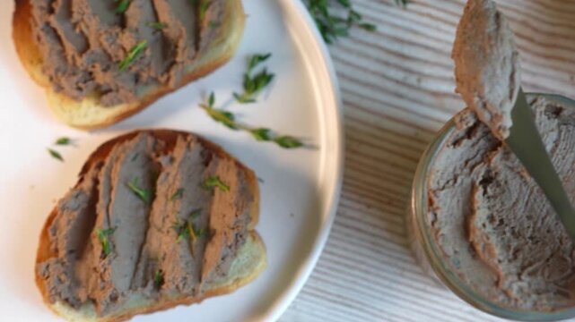 Homemade chicken liver pate in glass jar and toasted bread. Smooth chicken liver pate for healthy eating.