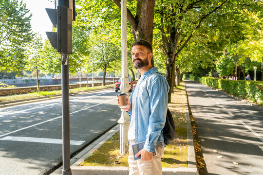 Man enjoying coffee walking urban street sidewalk