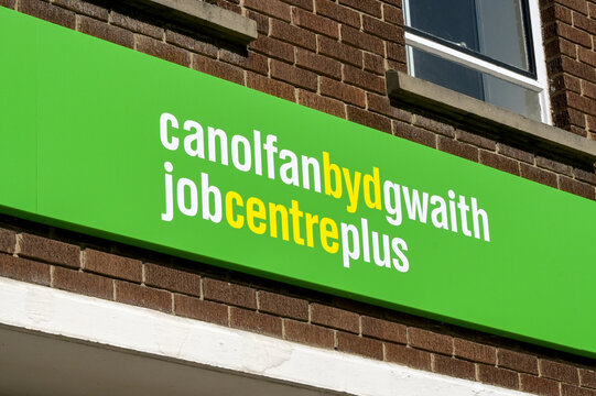 Porthmadog, Gwynedd, Wales, UK - 22 August 2026: Bilingual sign in English and Welsh above the entrance to the Jobcentre Plus office in the town centre of Portmadog