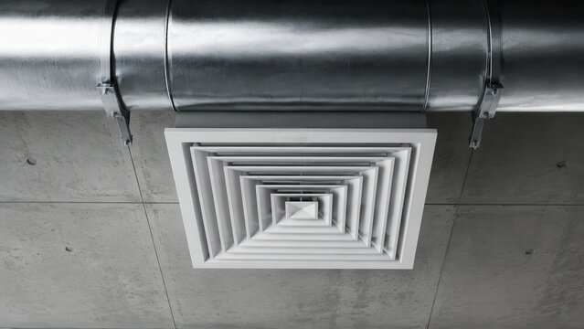 Industrial air-conditioning ducts and steel ventilation pipes under a ceiling.