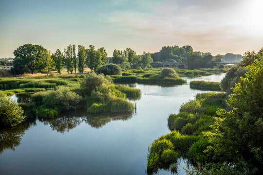 The calm waters of the River Agueda at sunrise in Ciudad Rodrigo, Salamanca, Spain