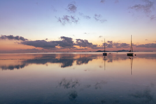 View of the Mar Menor at dawn with two boats on its waters, Punta Prima, Cartagena, Region of Murcia, Spain