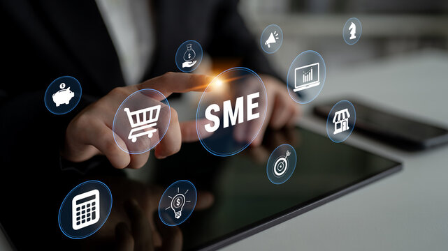 Business Professional Interacting with SME Icons on Digital Tablet for Small and Medium Enterprises Development and Online Strategy Implementation. Glyphic.