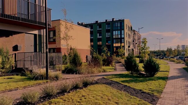 Townhouse in modern neighborhood. Duplex townhouse at lush greenery. Сontemporary apartment complex with townhomes. Modern building block. Walkway pathways at townhouse.
