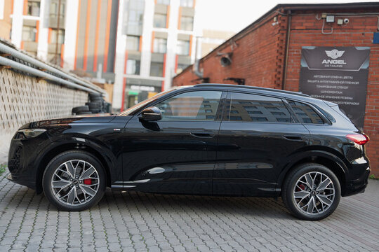 New Audi Q5 L III generation German SUV car parked on urban street pavement, modern black luxury crossover vehicle passenger automobile styling design exterior, automotive transportation industry. 