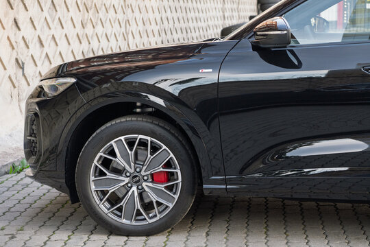 New Audi Q5 L III generation German SUV car parked on urban street pavement, modern black luxury crossover vehicle passenger automobile styling design exterior, automotive transportation industry. 