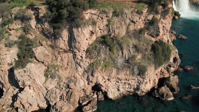 Aerial Tilt Up Reveal of Rocky Cliff and Lower Duden Waterfall