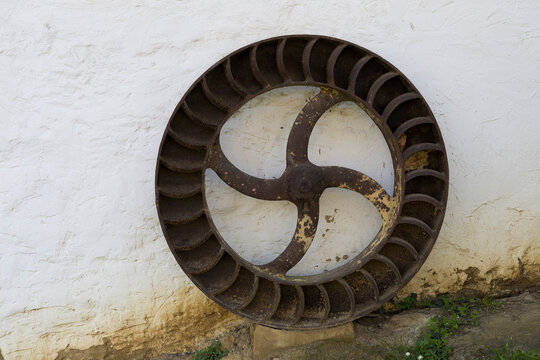 Iron wheel found on a wall in Beasain, Gipuzkoa, Spain during the day