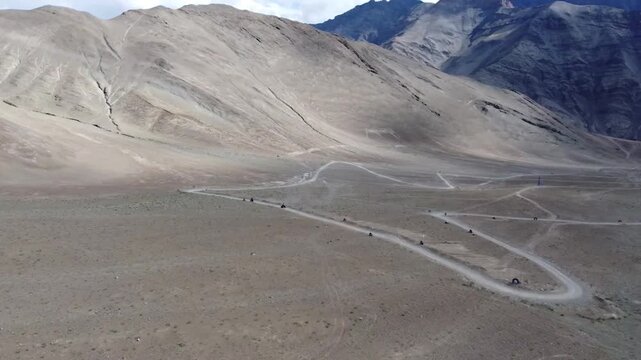 motorbike riding on a road in ladakh in indian Himalaya seen from the air