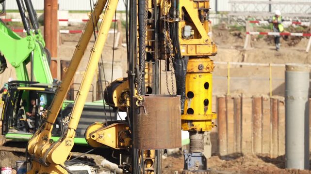 Large construction drilling machine performing deep foundation piling operations, showing heavy equipment and engineering works for modern urban infrastructure development