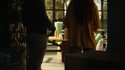 New homeowners hold hands in their first house, celebrating a shared life achievement, fresh start...