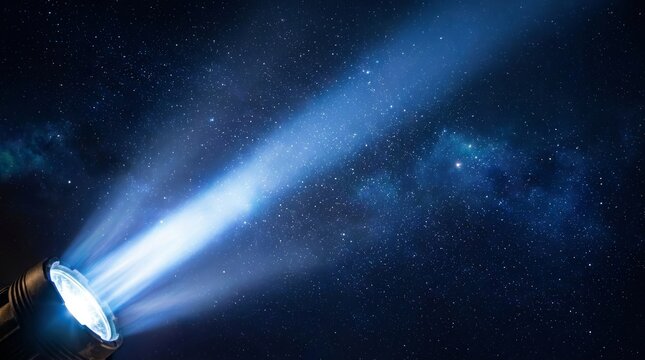 Bright beams of light from a searchlight illuminate a dark landscape filled with stars and constellations.