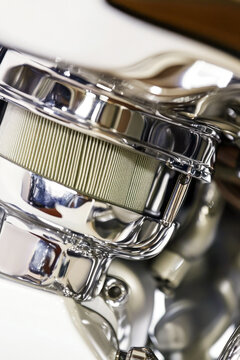 A detailed look at the inner workings of a chrome-plated motorcycle engine. vertical frame