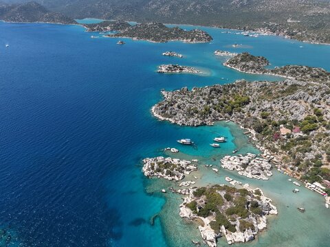 Aerial panoramic view of the beautiful Kekova islands and turquoise bays with anchored boats in Antalya, Turkey.