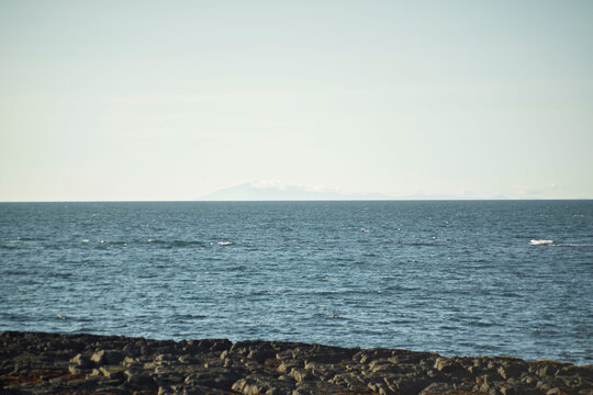 Minimalist seascape of blue ocean horizon and rocky shore in Akranes Iceland