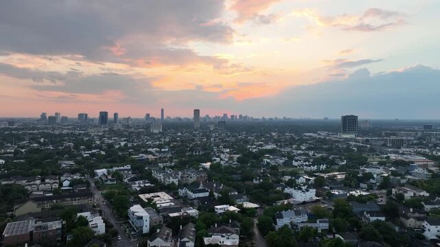 Aerial Drone Video Flying Over Montrose Neighborhood Toward the Uptown Houston Galleria Skyline at Sunset in Texas