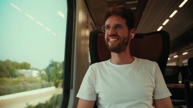 Man smiling on the train as he leaves for summer vacation relax departing