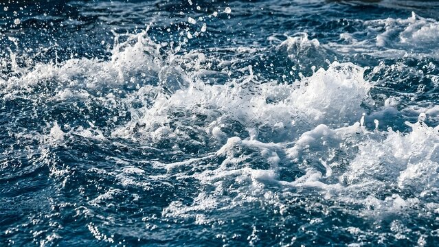 Dynamic blue ocean water with splashes and waves in motion