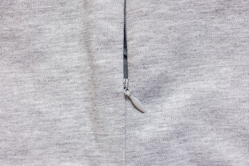 Gray knit fabric zipper close up texture © Iryna Miadzvedzeva