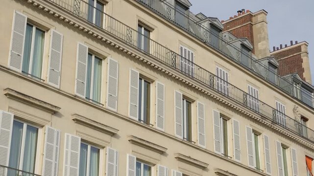 Parisian architecture featuring classic windows, balconies, and dormers on a historic building
