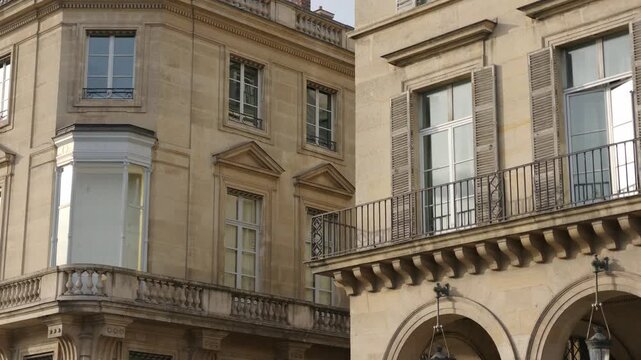 Historic stone buildings showing windows, balconies, and classic architectural details