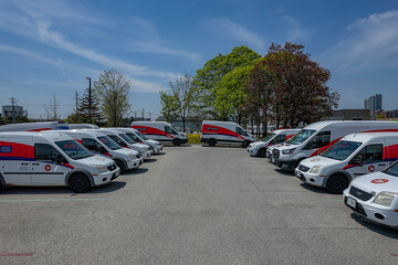 Fototapeta premium Canada Post delivery vans in a Toronto parking lot. The Crown corporation is ending door-to-door delivery for community mailboxes: Toronto, Ontario, Canada - May 17, 2026