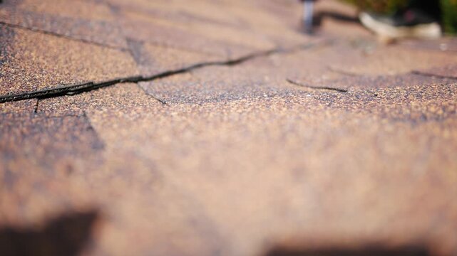 Man uses Caulk Gun to repair roof with Tar