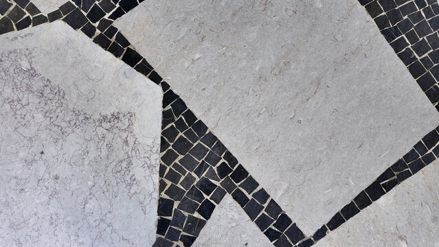 Portuguese limestone and black basalt mosaic pavement geometric texture