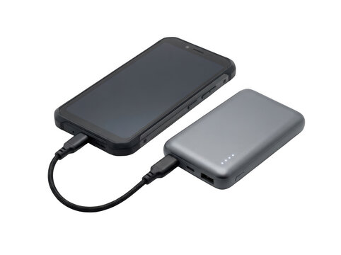 Black smartphone connected to a grey portable power bank with a short black usb cable for charging on a solid black background isolated on a transparent background