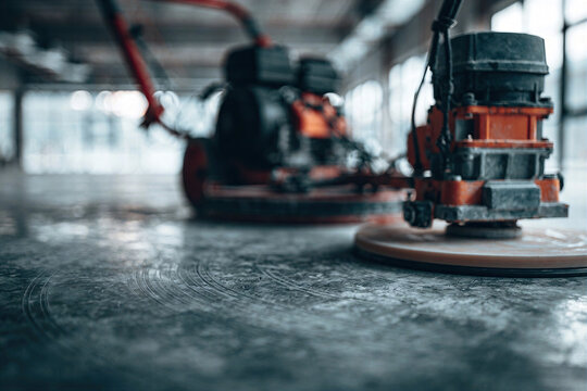 Power Trowel in Action: Vibrant Construction Tool on Freshly Smoothed Concrete Floor, Bright Interior Setting