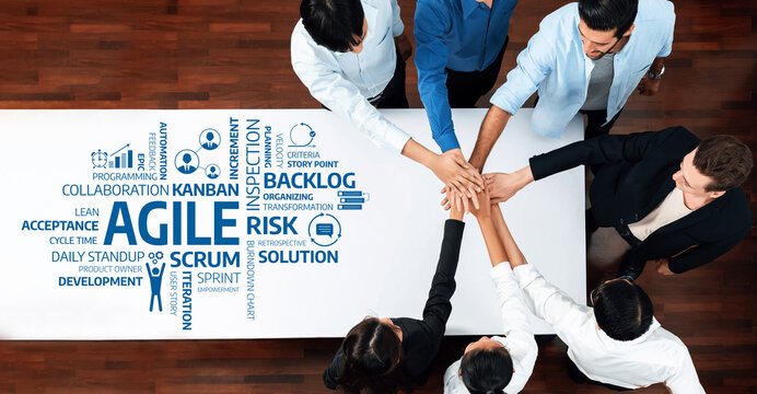A diverse group of professionals collaborates at a table using Agile methods. They focus on scrum, kanban, and project management tools to enhance teamwork and productivity. Amity
