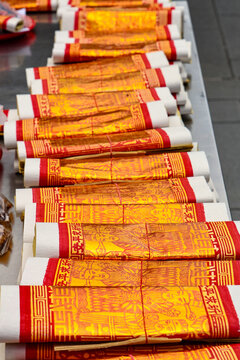  stacks of golden Joss papers arranged neatly on a table for religious ceremonies and offerings