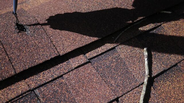 Man Attempts to use Tar Caulk to fill hole on Roof.