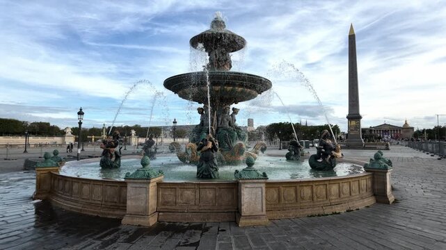 Fontaine des Mers splashing water in Place de la Concorde with the Luxor Obelisk nearby