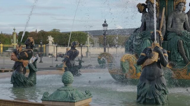 Detailed view of the Fontaines des Mers fountain sculptures splashing water in a Parisian square
