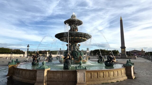 Fontaine des Mers flowing water in Place de la Concorde with the Luxor Obelisk