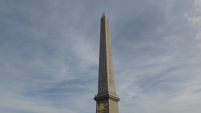 Luxor Obelisk from Egypt displaying hieroglyphics against a blue sky