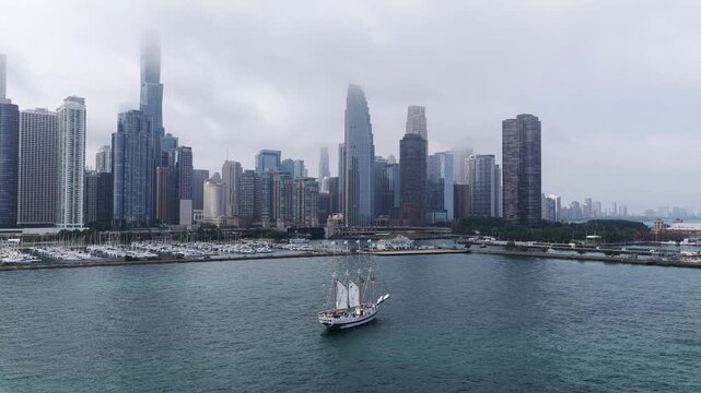 Arieal view of Sailboat Sailing on Lake Michigan Against Chicago Skyline, Overcast Day&rdquo;