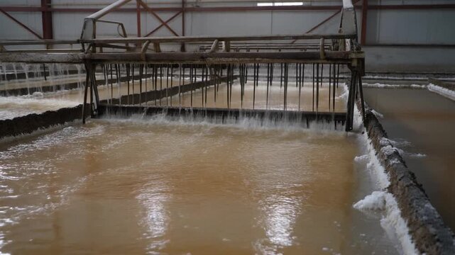 Salt harvesting rake line with water flowing steadily across it