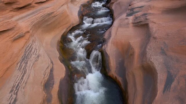 Sandstone cliff face with water flowing steadily across it