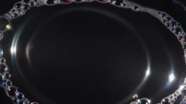 Soap bubble film with light sweeping slowly across the surface