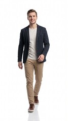 Fototapeta premium Handsome young man in a smart casual dark blue blazer and beige chinos walking confidently forward, isolated on white background.